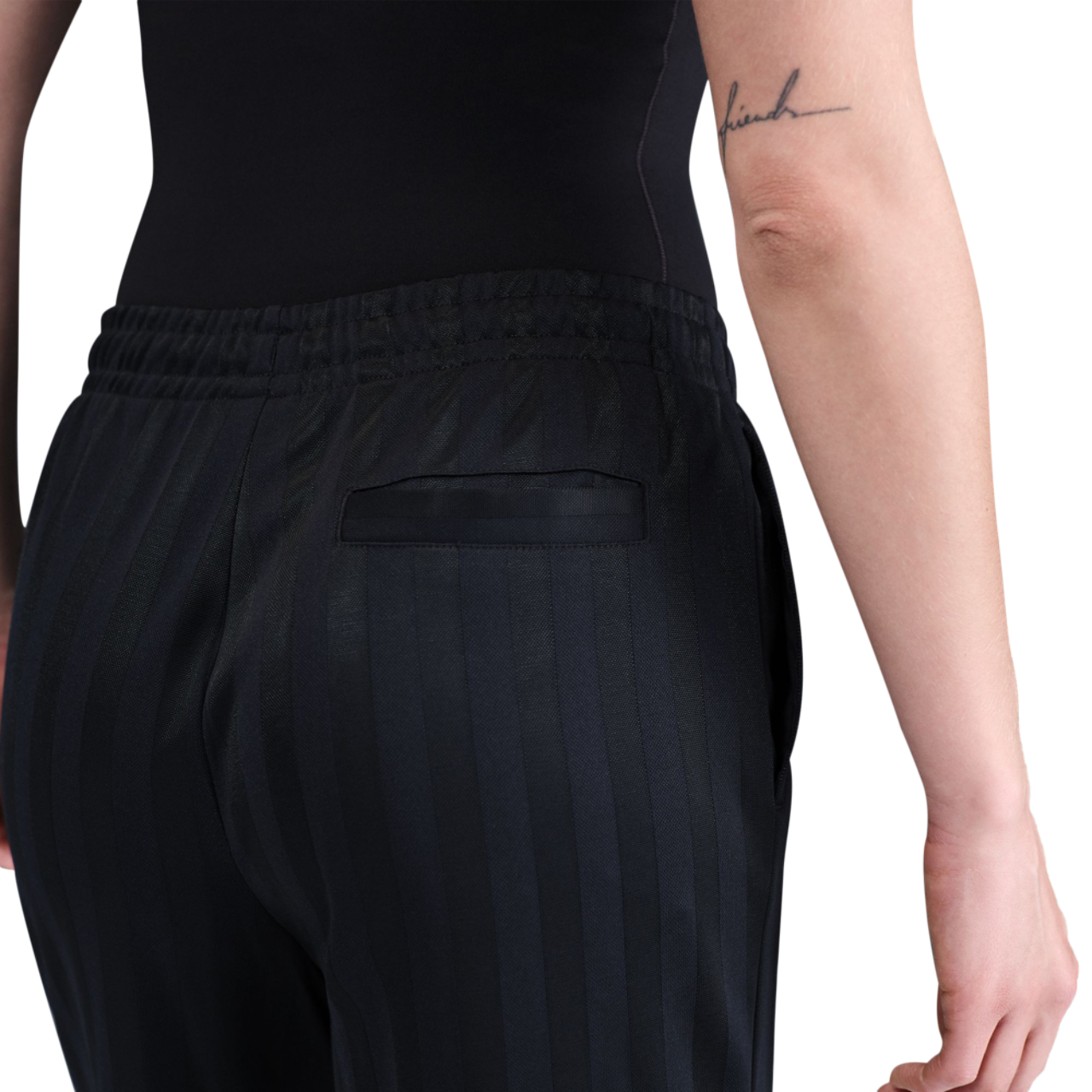 Nike Sportswear Mid-Rise Loose Jacquard Striped Track Pants Image 5 of 5. Tap to open photo gallery.