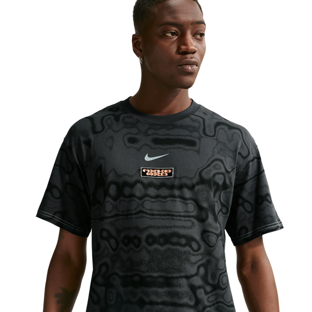 Nike NSW AM Day AOP Loose Tee Image 1 of 4. Tap to open photo gallery.
