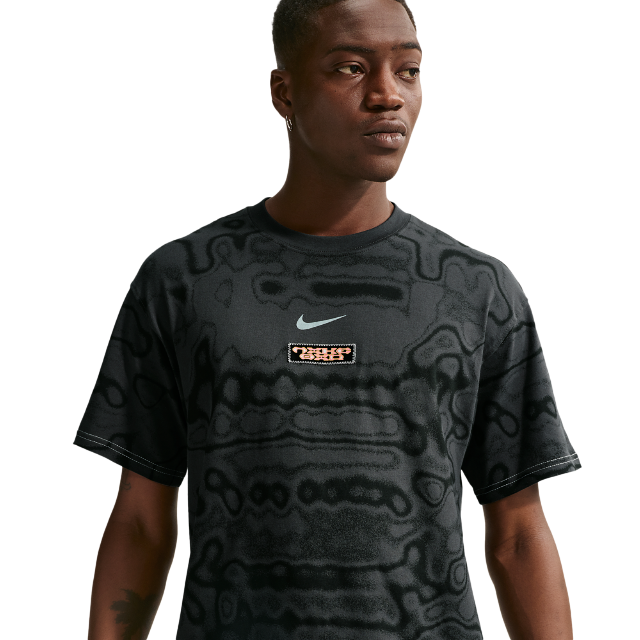 Nike NSW AM Day AOP Loose Tee Image 1 of 4. Tap to open photo gallery.
