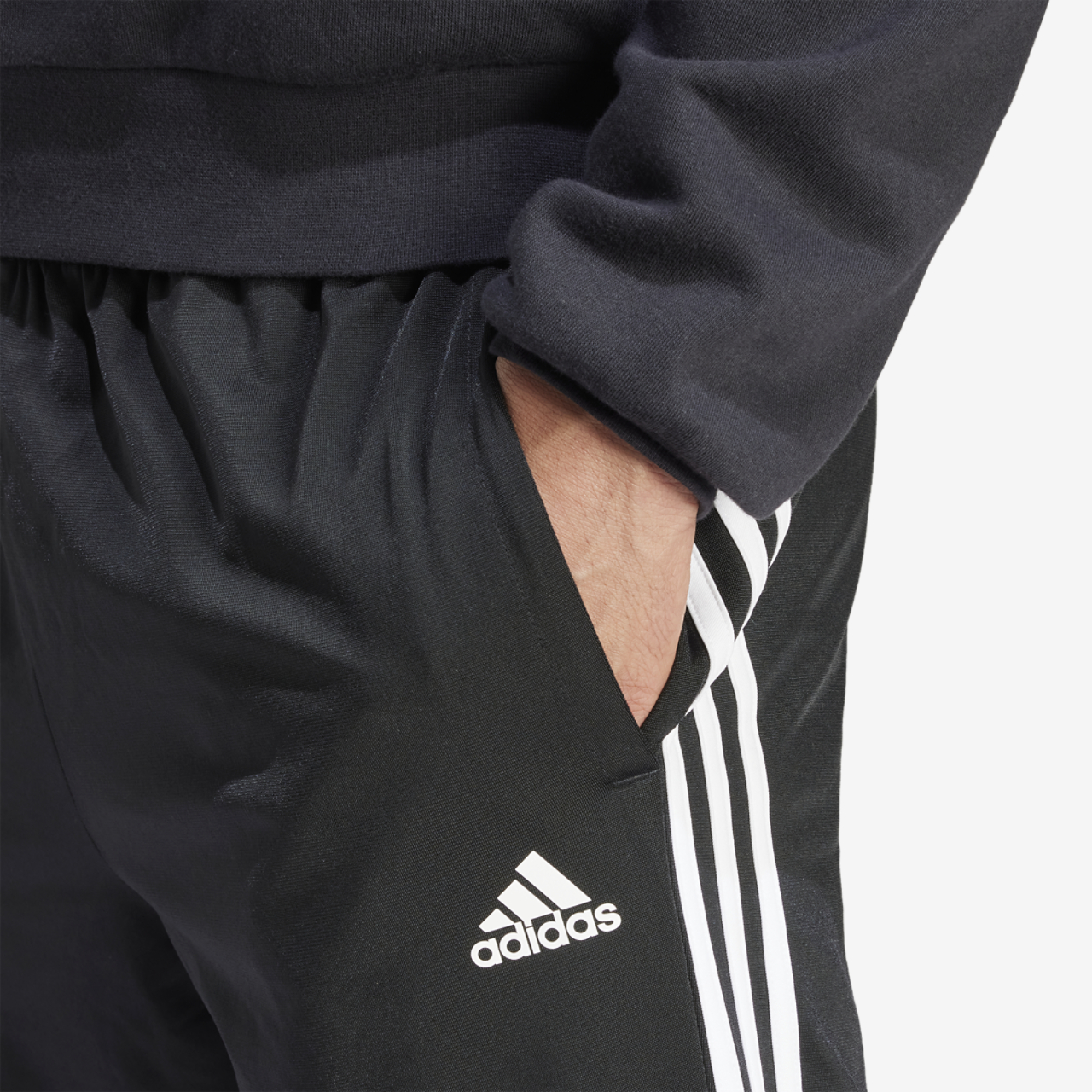 adidas Essentials Warm-Up Tapered 3-Stripes Track Pants Image 3 of 5. Tap to open photo gallery.