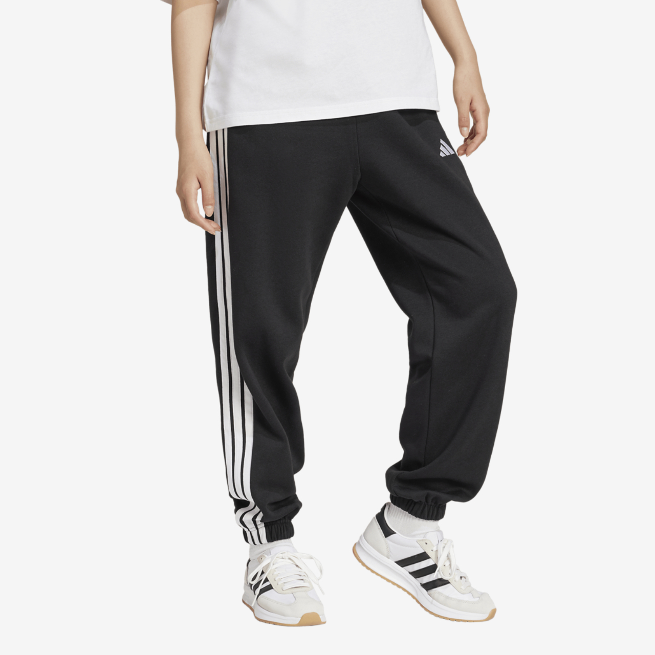 adidas Essentials 3-Stripes Fleece Loose Pants Image 1 of 5. Tap to open photo gallery.